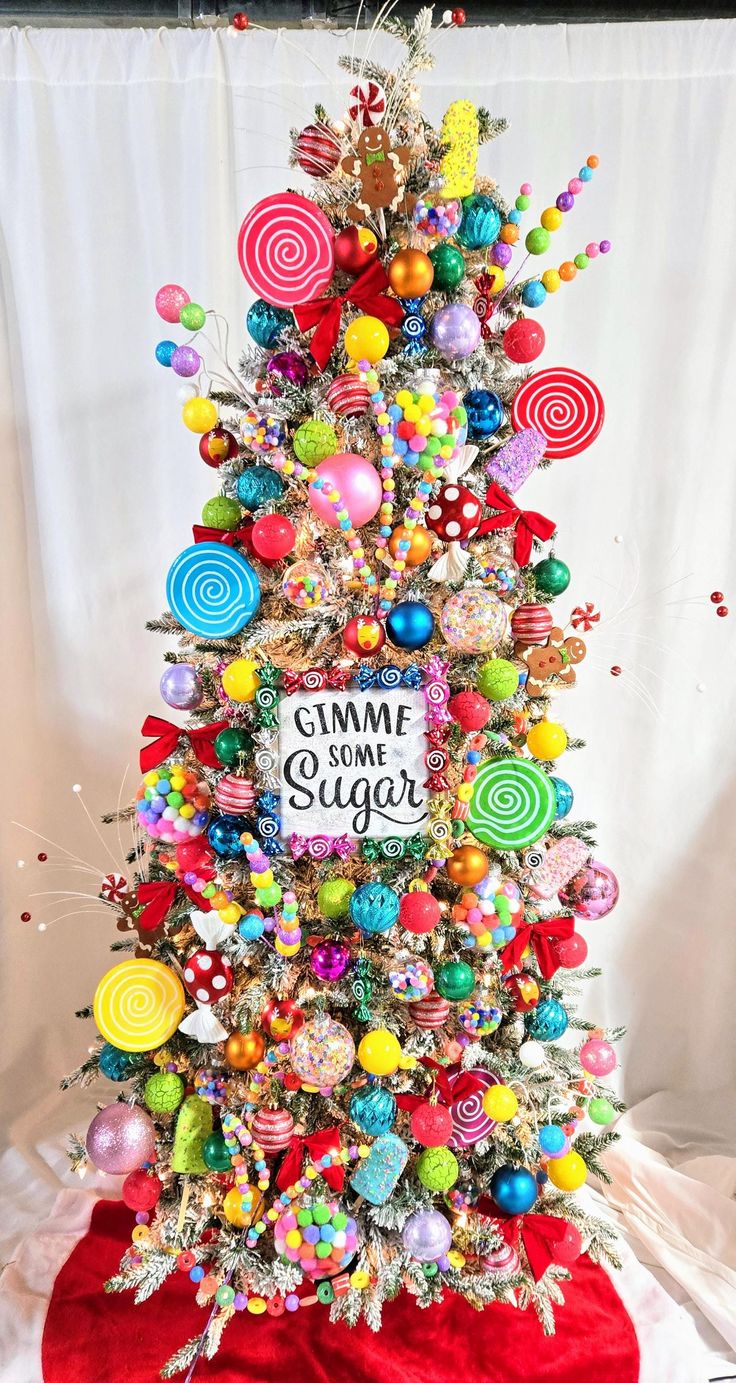 a christmas tree decorated with candy, lollipops and candies is on display