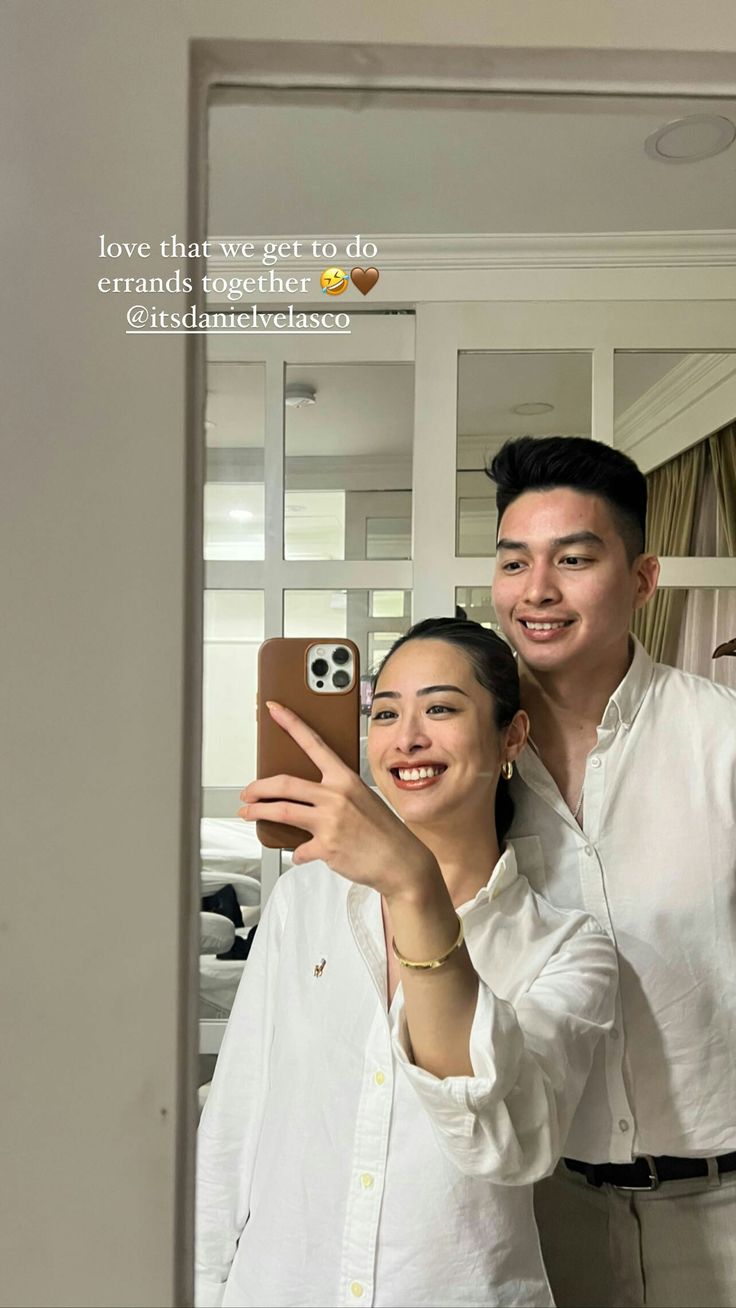 a man and woman taking a selfie in front of a mirror with the caption love that we get to do