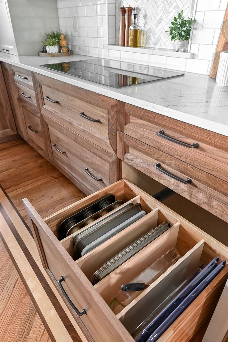 an open drawer in the middle of a kitchen