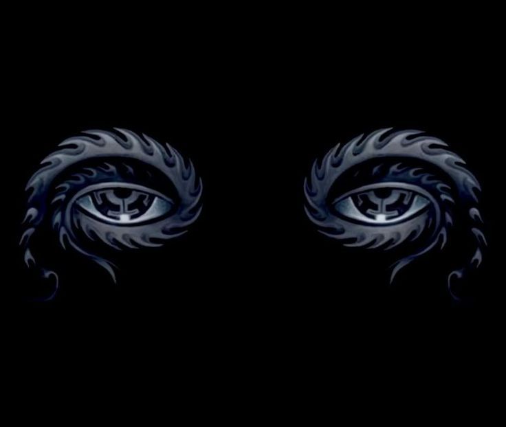 two eyes with black and white designs in the middle, against a dark background that appears to be made up of flames