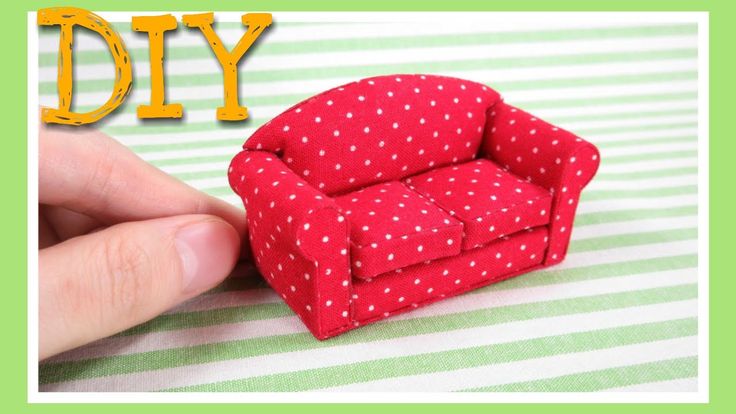 a miniature red chair sitting on top of a green and white striped tablecloth with the words diy written above it