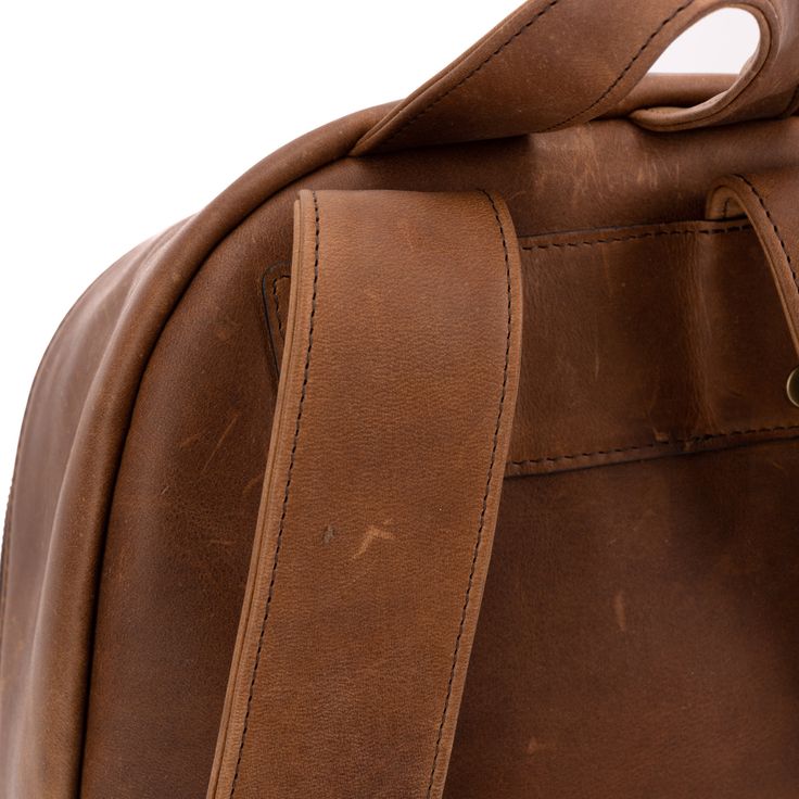 A professional upgrade to the familiar workhorse. The expected features—plenty of interior storage, a handy exterior pocket, comfortably shoulder straps, and an iconic top loop handle—ensure the utility of the bag while the subtle upgrades—an angled zipper into the main compartment for easier access, clever pleats giving the exterior pocket its depth, and, of course, the unique grain and details of the reclaimed leather—will distinguish you from the pack. Rugged Bag With Adjustable Strap For Everyday Use, Rugged Backpack With Adjustable Strap For Everyday Use, Rugged Everyday Satchel With Adjustable Strap, Classic Waxed Finish Backpack, Classic Waxed Finish Standard Backpack, Everyday Rugged Satchel With Adjustable Strap, Classic Everyday Backpack, Rugged Standard Backpack With Adjustable Strap, Rugged Backpack With Leather Handles