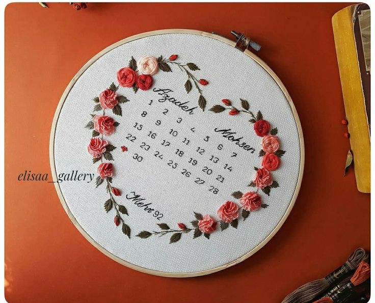 a cross stitch heart with roses on it and the date in each month is shown