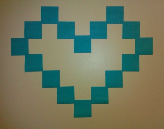 an image of a heart made out of blue squares on a white wall with the word love written across it