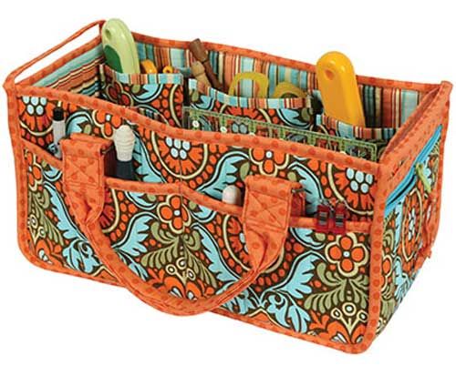 an orange and blue paisley pattern pen holder with pens, scissors and pencils in it