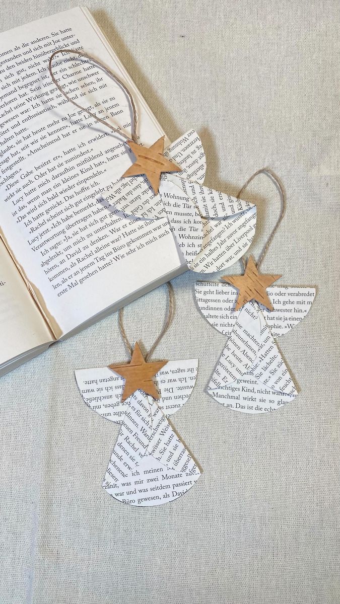 an open book with wooden stars hanging from it