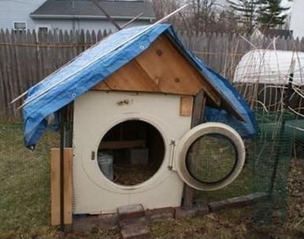 a dog house made out of an old washer and dryer in the yard