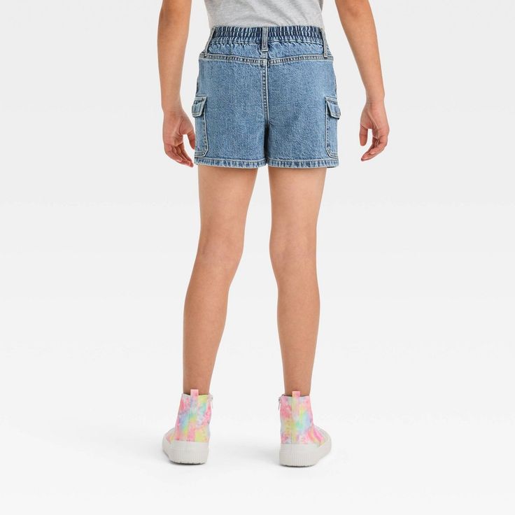 Update their casual warm-weather staples with these High-Rise Cargo Jean Shorts from Cat & Jack™. These cargo-style jean shorts feature front and side flap pockets to add functional style to their look. Made from stretchy denim fabric in a regular fit, the shorts offer easy movement and comfy wear. Plus, the belt loops and a front fly button and zipper closure provide a secure, adjustable fit. Your child can pair them with their favorite top and a pair of sneakers to complete the coordinated ens Cargo Jean Shorts, Functional Style, Comfy Wear, Cargo Style, Girls High, Cargo Jeans, Cat & Jack, Denim Fabric, Girls Shopping