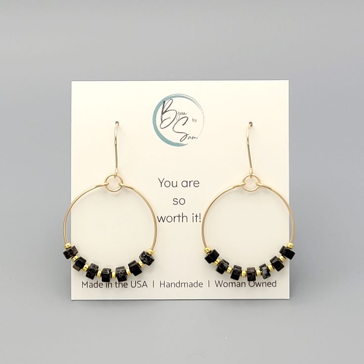 These gold hoops, adorned with black jasper beads, add a touch of eclectic elegance to any outfit. Perfect for any boho babe, these earrings are a must-have for your collection. 14k Gold Filled Wire Measure approximately 1.125" in diameter Earrings Hang 1.75" from top of ear wire Black Jasper Gemstones Polished to a high shine Sent in a Gift Box with Polishing Cloth Handmade in Montana Eclectic Elegance, Black Jasper, African Turquoise, Jasper Beads, Jasper Gemstone, Gold Hoops, Jewelry Packaging, Ear Wire, Christmas Shopping