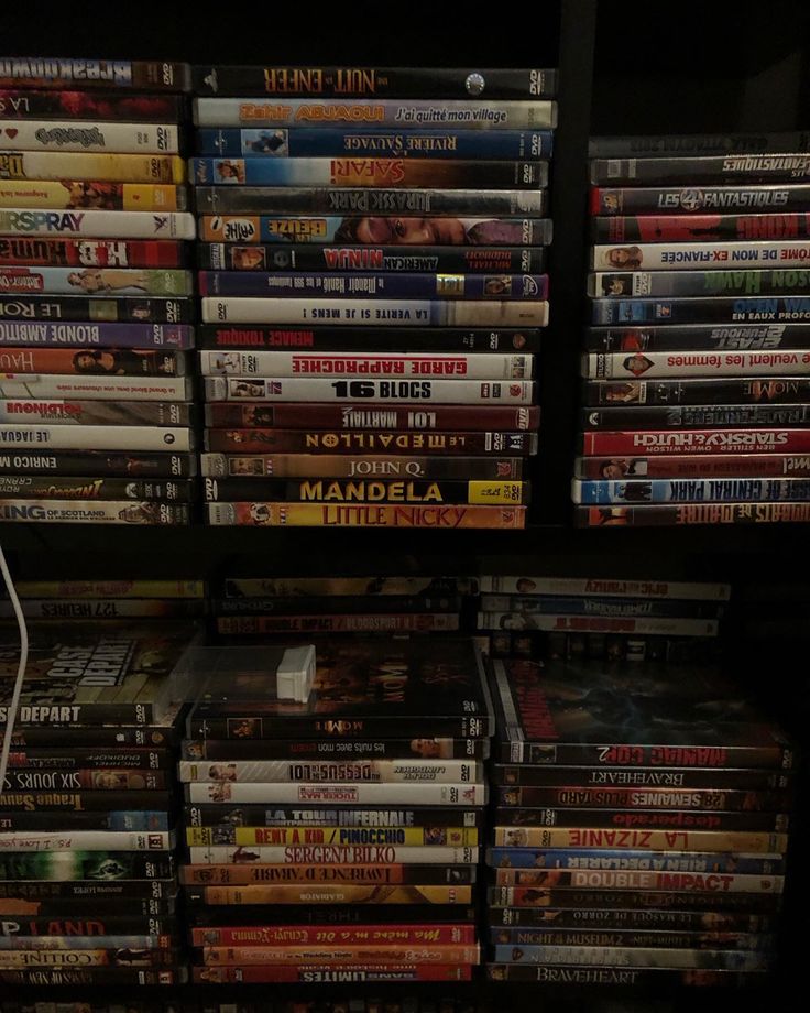 many dvds are stacked on top of each other