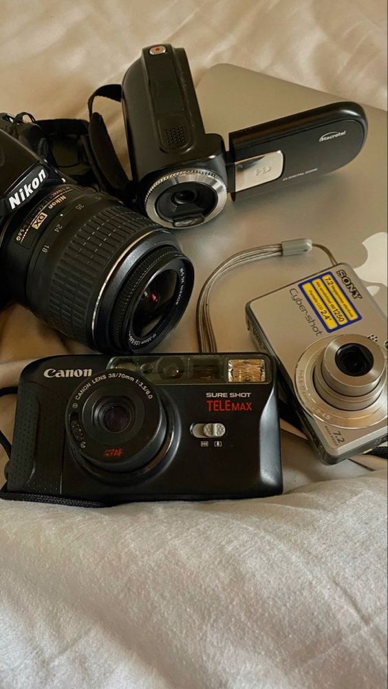 there are many different types of cameras on the bed