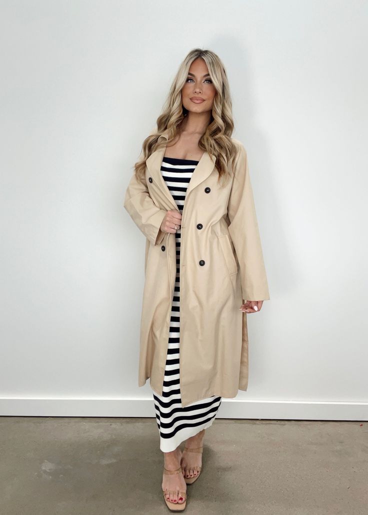 Introducing our Oversized Trench Coat, the ultimate transition piece for a sophisticated and elevated look. With pocket details, button closures, and a collared neckline, this long trench coat is not only stylish, but also soft and comfortable. The neutral color and waist tie detail make it perfect for layering, keeping you warm and chic for any occasion, from dinner to drinks or shopping. Classy, just like you. Fabric 80% Polyester, 20% Cotton Lining 97% Polyester, 3% Spandex Dry clean only. Oversized Trench, Oversized Trench Coat, Long Trench, Long Trench Coat, Neutral Color, Pocket Detail, Waist Tie, Dresses Xs, Neutral Colors