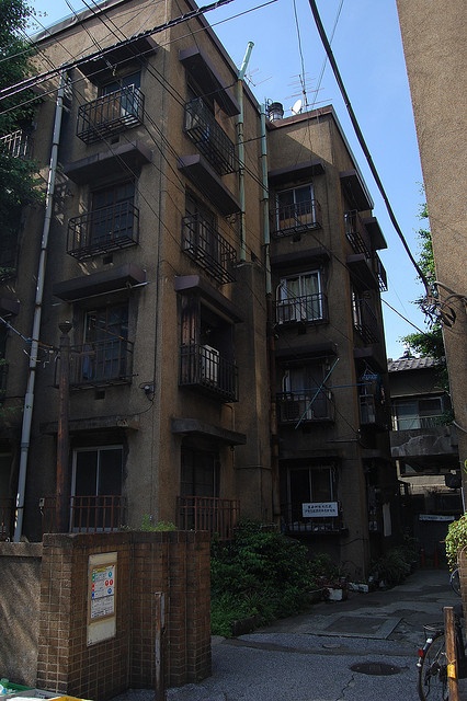 an apartment building with many balconies on the second floor