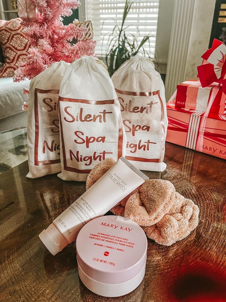 the contents of a spa gift set on a table next to two bags with gifts in them