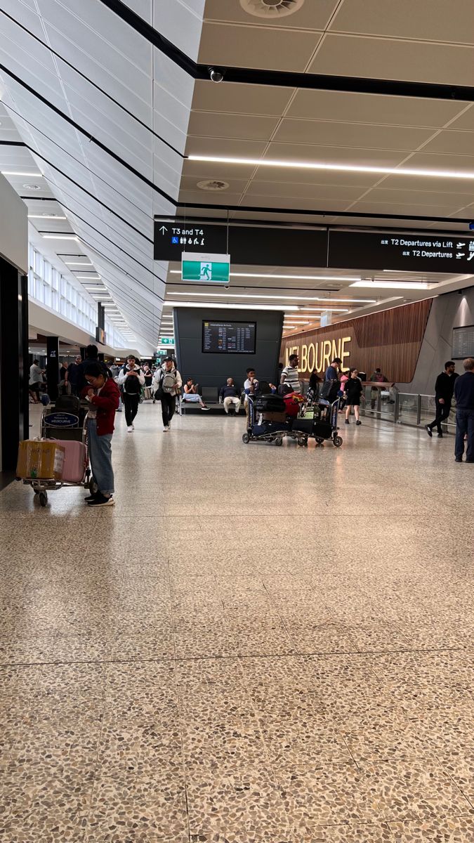 people are walking through an airport terminal with their luggage and baggage bags on the ground