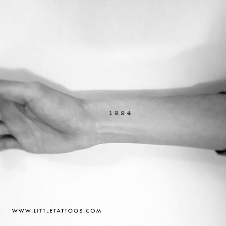 a person's arm with a small tattoo on it