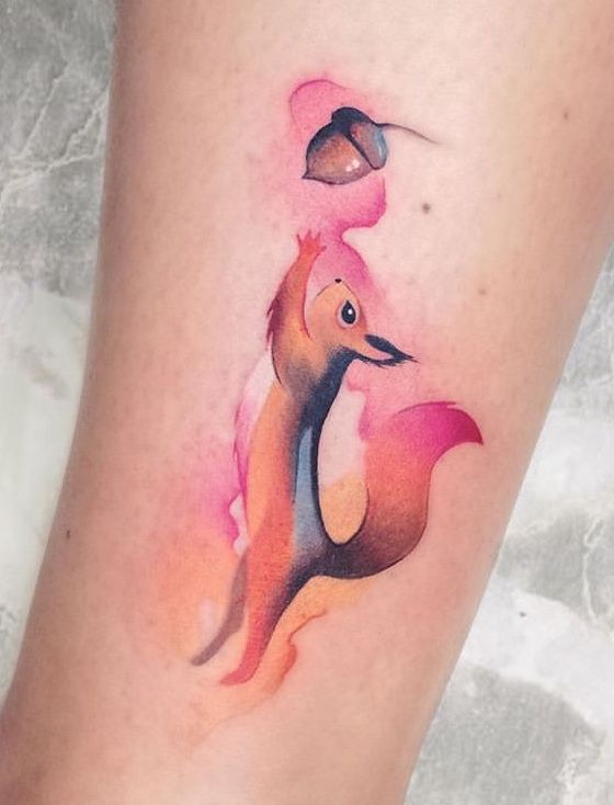 a watercolor tattoo of a fox on the right side of the leg with an acorn