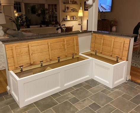 a kitchen with two large wooden cabinets sitting next to each other on top of a tile floor