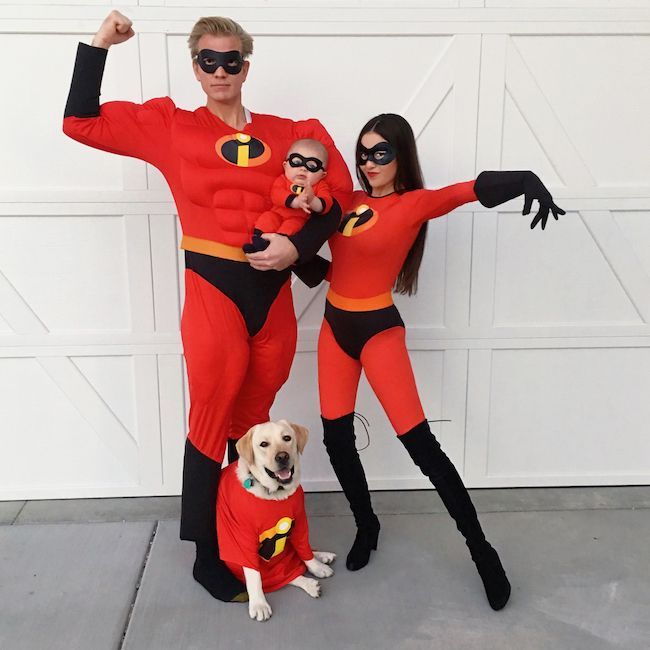 two people and a dog are dressed up as the incredible spider man and incredible woman