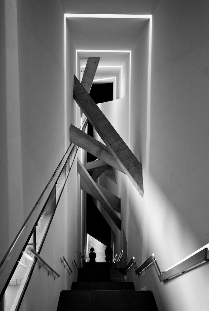 black and white photograph of stairs leading up to the second floor in a modern building