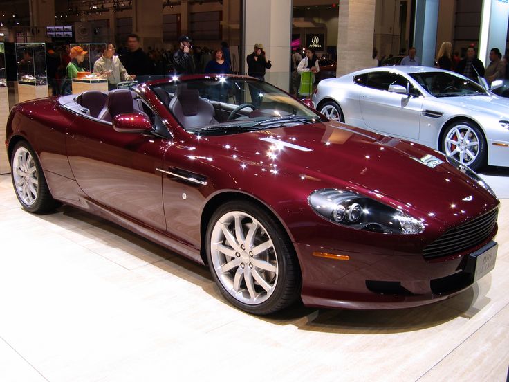 a red sports car is on display in a showroom