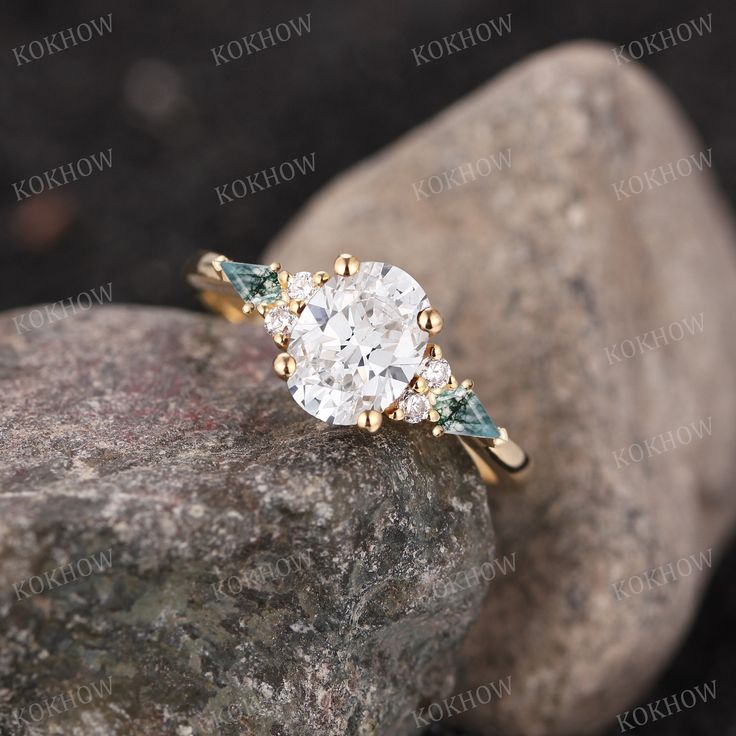 a close up view of a diamond ring on top of a rock