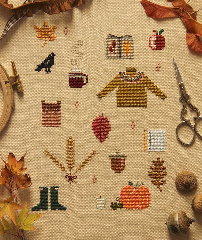 a cross stitch pattern with autumn items on it