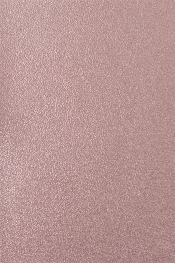 a pink leather textured surface with some small scratches on the top and bottom half