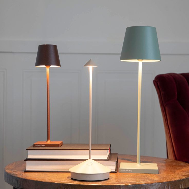 two lamps sitting on top of a wooden table