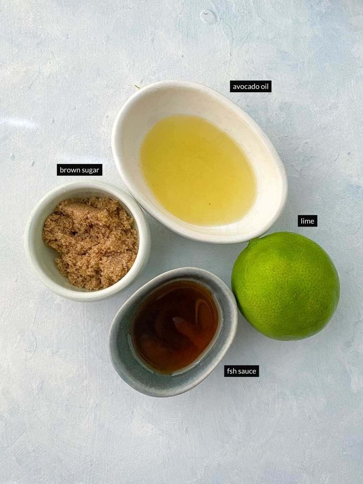 the ingredients to make an apple cider are shown in small bowls on a white surface