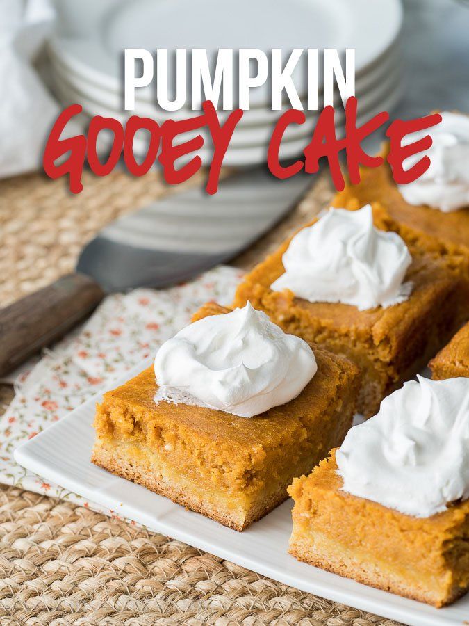 pumpkin gooey cake on a white plate with whipped cream in the middle and text overlay that reads, pumpkin gooey cake