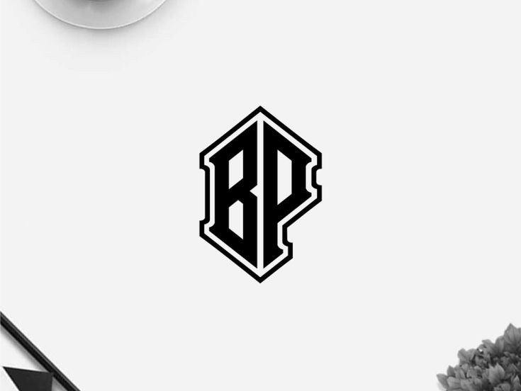 the letter b is shown in black on a white wall next to a coffee cup