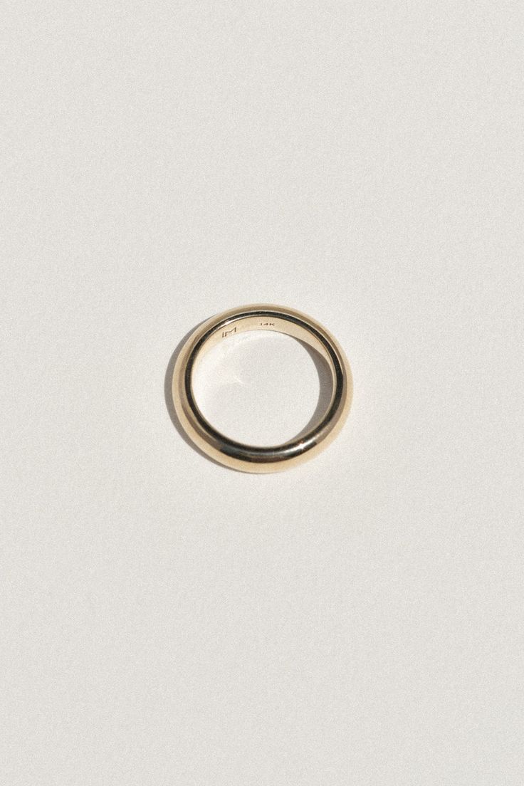 The Tourne Ring is our first wedding band offering to our core collection. Each band is thoughtfully crafted in recycled gold, available in white or yellow, in 14k or 18k. Our intention while designing the Tourne Ring was to create a piece that felt luxurious and significant. Each band has a beautiful heft to it, comfortable, but a subtle reminder of the connection to your beloved. With a gentle, rounded form on the outside, and a soft finish on the inner edge for comfort, the Tourne Ring is an Timeless Wide Band Yellow Gold Ring, Minimalist Hallmarked Dome Ring For Everyday, Everyday 14k Gold Round Band Ring, 14k Gold Rings For Everyday Wear, 14k Gold Everyday Rings With Round Band, Timeless 14k White Gold Wide Band Ring, Everyday Yellow Gold Rings In Recycled Gold, Classic Yellow Gold Stackable Rings, Classic 14k Gold Wide Band Ring For Anniversary