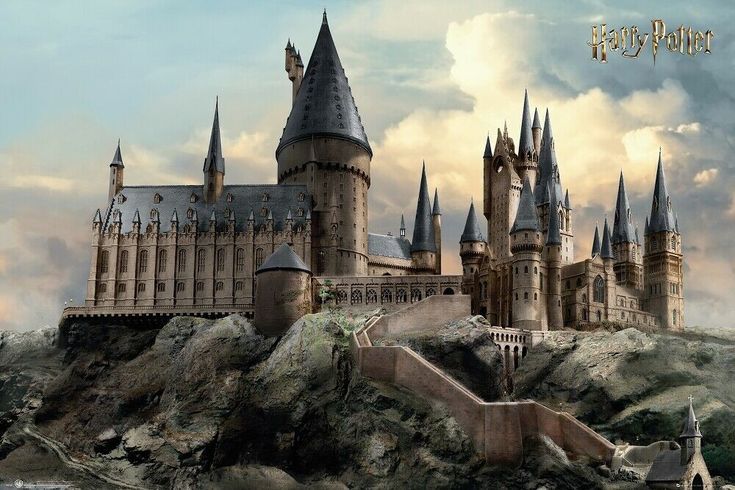 the hogwarts castle is built on top of a hill in front of a cloudy sky