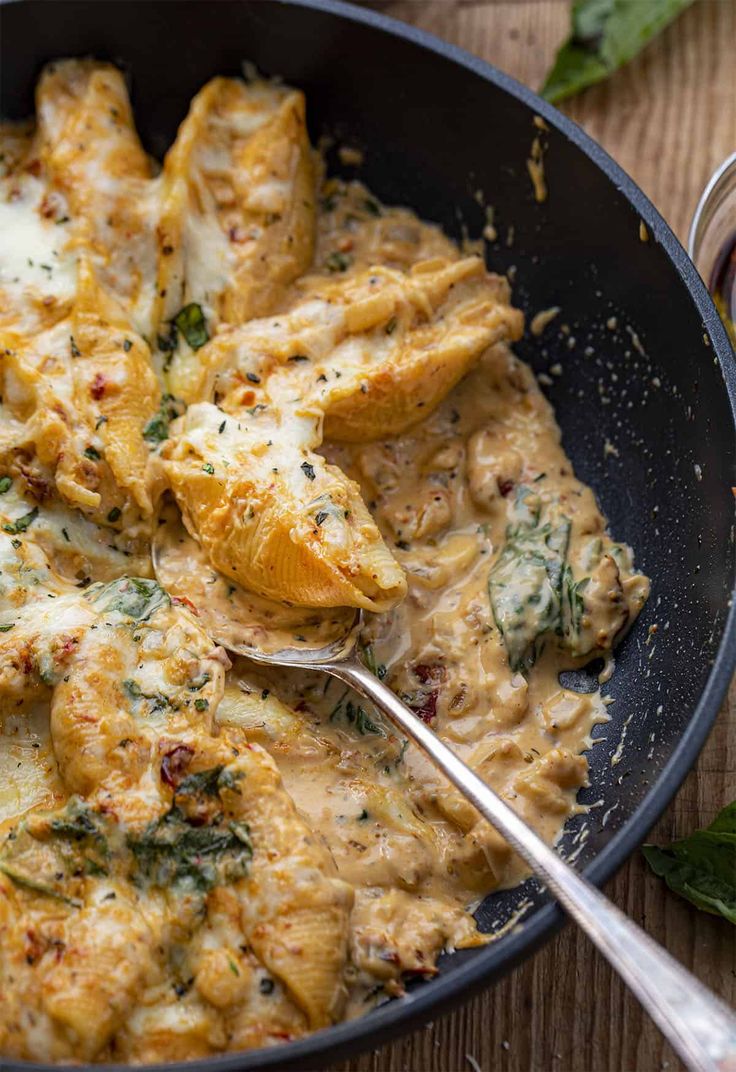 a skillet filled with chicken and cheese