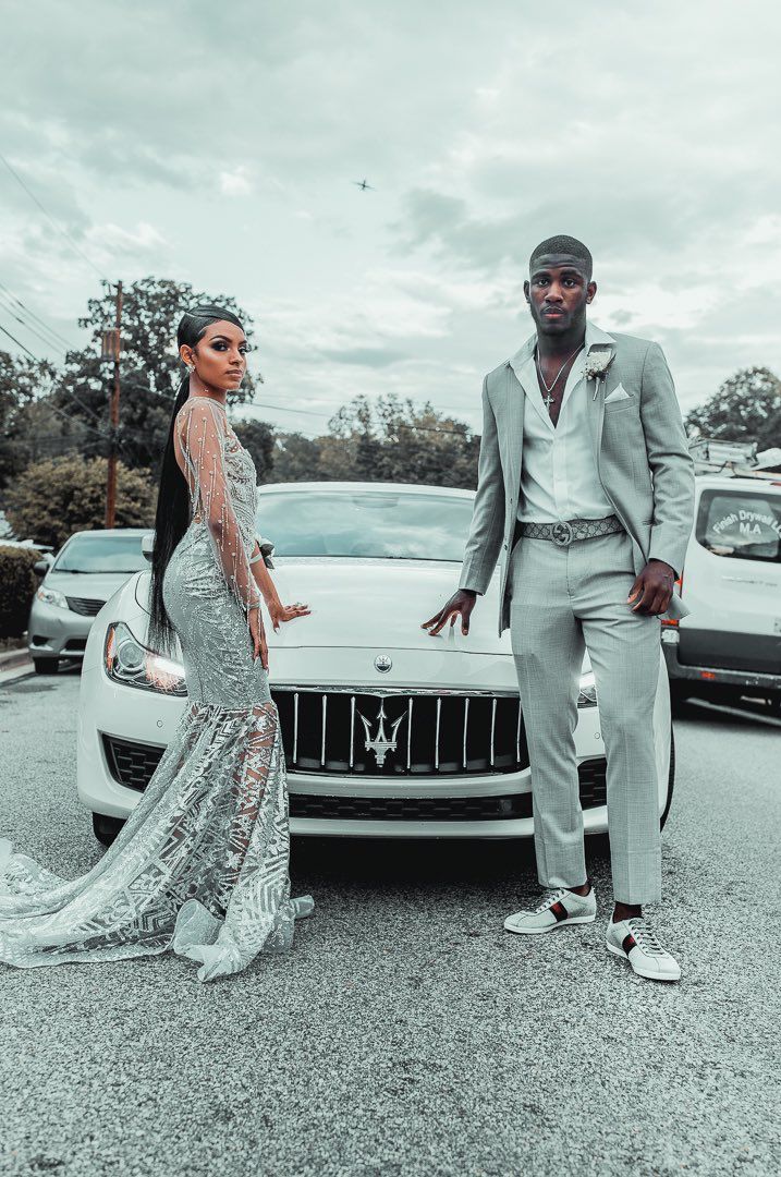 Grey Prom Dress Couple, Prom 2023 Black Couples, Black And Silver Prom Suits For Guys, Silver Suit For Men Prom, Prom Outfits Black Couples, Silver Prom Outfits For Couples, Black Couples Homecoming Outfits, Silver And Black Prom Suit, Prom 2k23 Black Couple