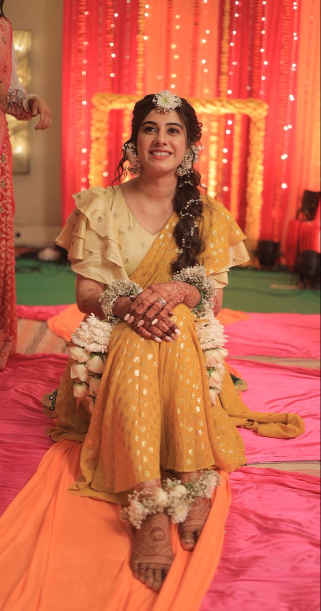 a woman sitting on top of a pink floor