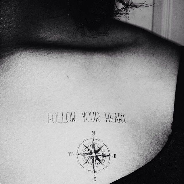 a man with a compass tattoo on his chest that says follow your heart and the words below it