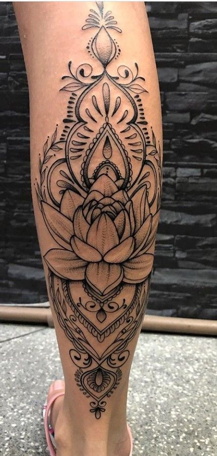 a woman's leg with a tattoo on it and a flower in the center