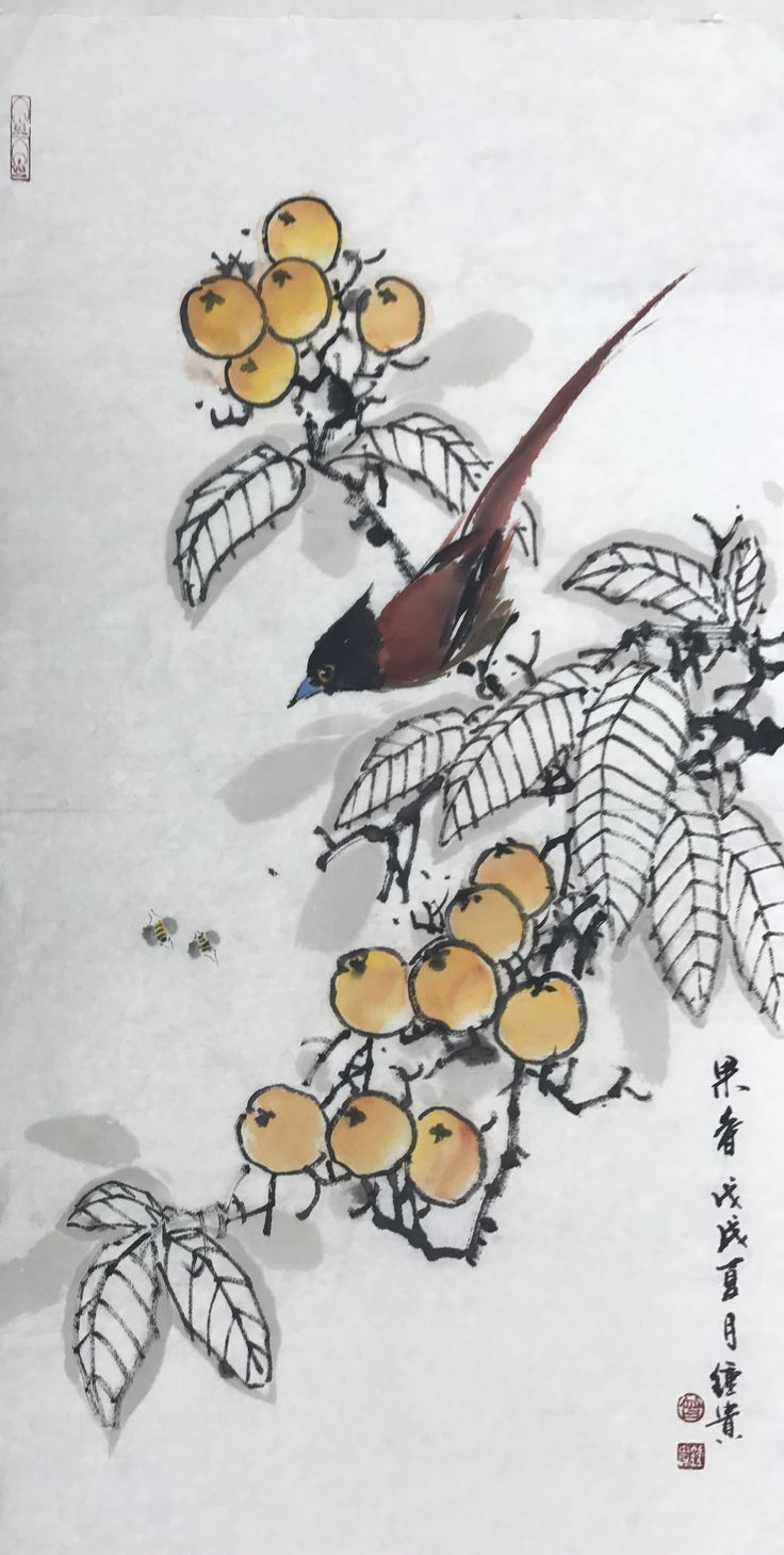 a bird sitting on top of a tree filled with leaves and oranges in the snow