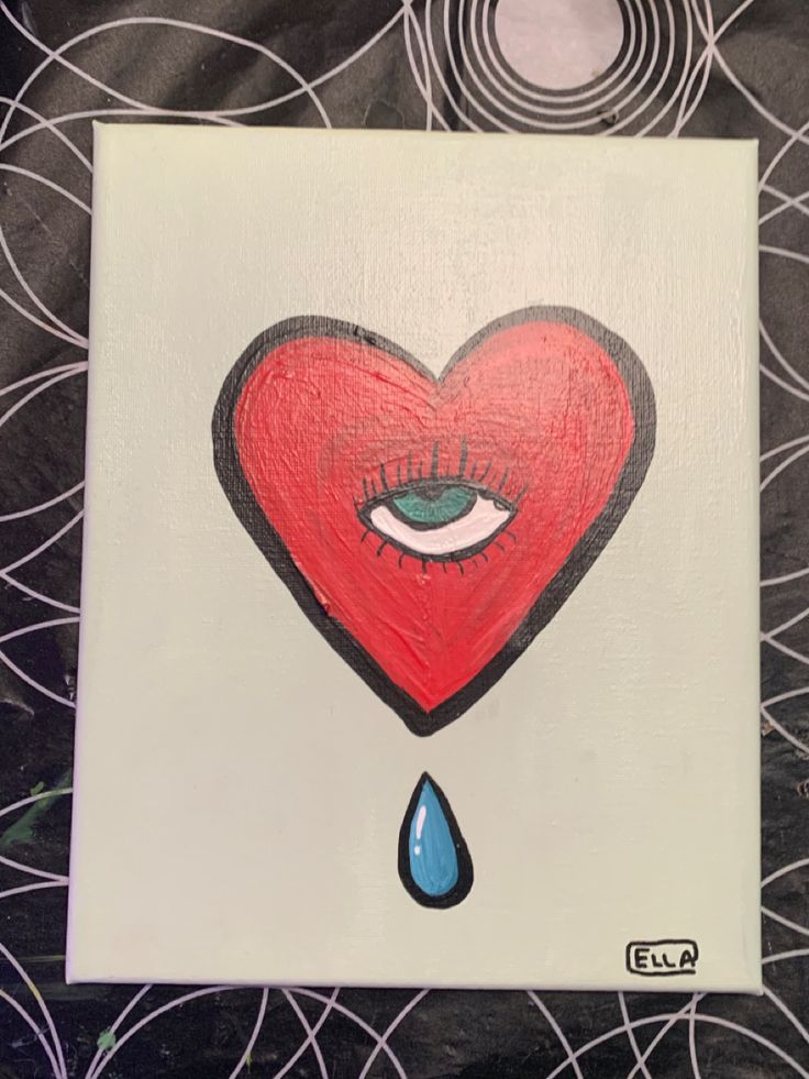 a red heart with an eye on it and a drop of water in the middle