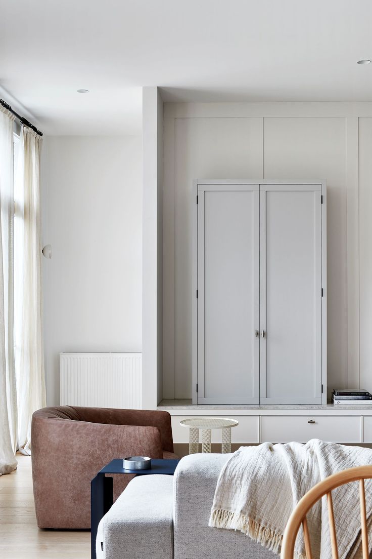 a living room filled with furniture and white walls