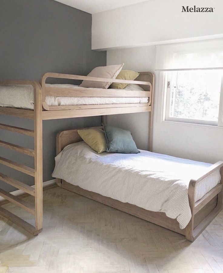 two bunk beds in a small room with white tile flooring and walls painted gray