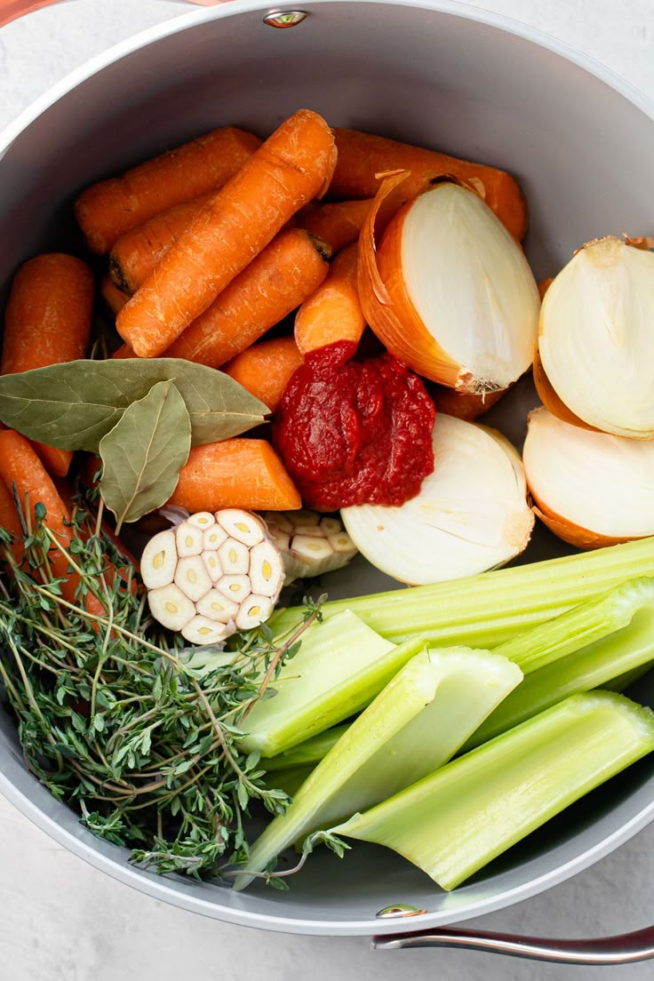 carrots, celery and other vegetables in a pot