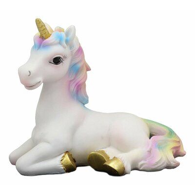 a toy unicorn laying down on the ground