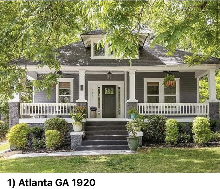 a gray house with white trim on the front porch