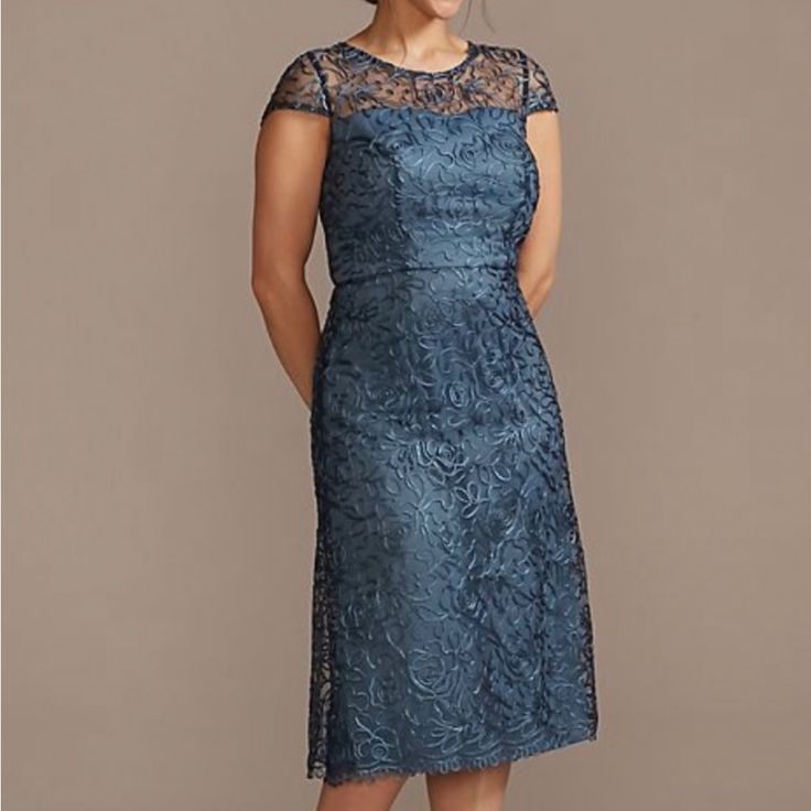 a woman wearing a blue lace dress