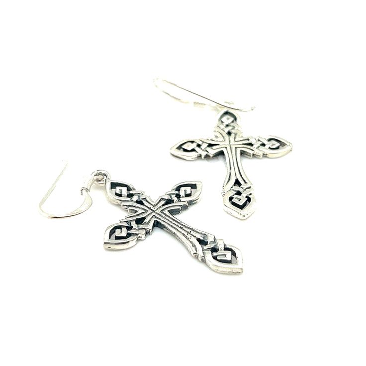 Step into a world of enchantment with our Celtic Knot Cross Earrings. These cross earrings carry the essence of eternity and interconnectedness. The delicate weaving patterns speak to the unbreakable bond between humanity, nature, and the divine. Embracing the allure of an era bygone, their lightweight design ensures comfortable wear, inviting you to flaunt them with ease and grace. Materials: .925 Sterling Silver Approximately 2.75 Inches long and .75 inches wide Elegant Pierced Cross Jewelry, Sterling Silver Cross Earrings With Ear Wire, Elegant Cross Pendant Jewelry For Pierced Ears, Gift Single Cross Pendant Earring, Cross-shaped Jewelry With Matching Earrings, Pierced Cross Pendant Jewelry Gift, Pierced Crucifix Jewelry Gift, Nickel Free Adjustable Cross Earrings, Sterling Silver Cross Pendant Earrings For Gift