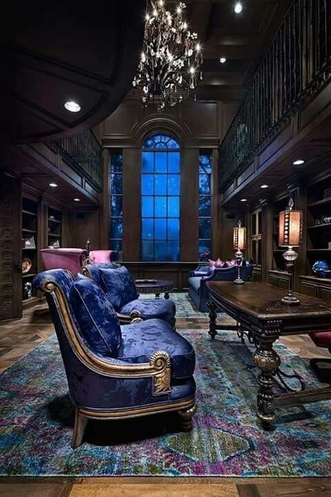 a living room filled with furniture and a chandelier