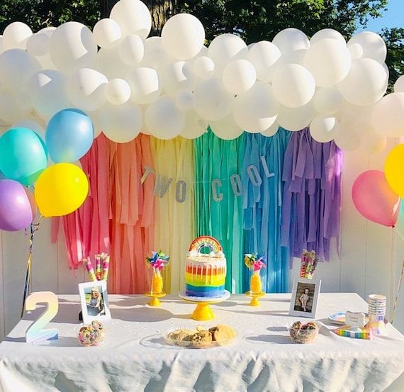 a rainbow themed birthday party with balloons and streamers